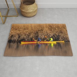 Two rowers sail on the river Rug